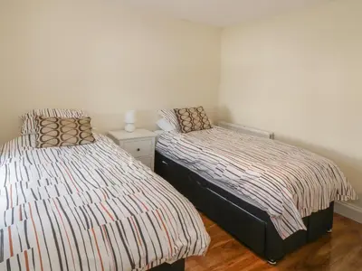 two beds in a small room with at 7 Cummertrees in Annan