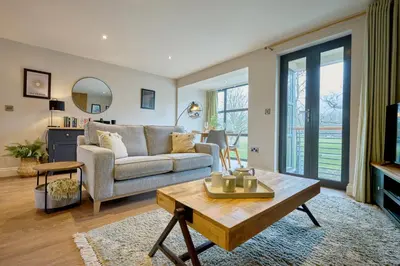 a living room with a couch and a table at Riverside Park 3 in Keswick
