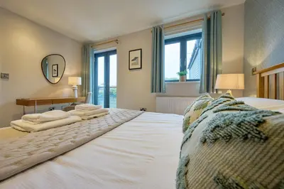 a bedroom with two beds with towels on them at Riverside Park 3 in Keswick