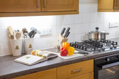 a kitchen counter with a pot on a stove at Honeybee Cottage in Penrith