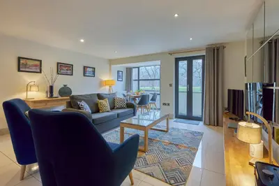 a living room with a couch and a table at Riverside Park 2 in Keswick