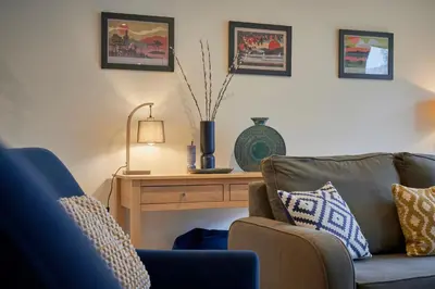 a living room with a couch and a table at Riverside Park 2 in Keswick