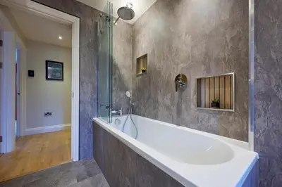 a large bathroom with a tub and a shower at Riverside Park 4 in Keswick