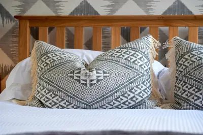 a group of pillows on a bed at Riverside Park 4 in Keswick