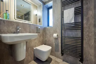 a bathroom with a sink and a toilet and a mirror at Riverside Park 4 in Keswick