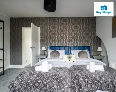 a bedroom with a large bed with a dog on it at NEW Four Bedroom House By Keysleeps Short Lets Workington Contractor Leisure Beach Location Lake District in Siddick