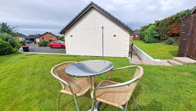 a table and two chairs in a yard at Gretna Getaway in Gretna