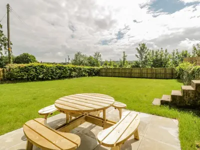 a picnic table and two benches in a yard at North Firbank - Culzean Castle in Maybole