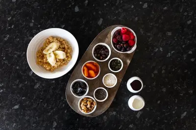 a table with a bowl of cereal and a bowl of fruit at Bojangles Guest House in Gretna Green