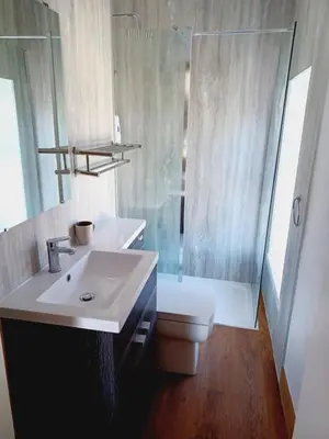 a bathroom with a sink and a toilet and a shower at Voyage Hostel - Ensuite Family Rooms with shared kitchen in Douglas