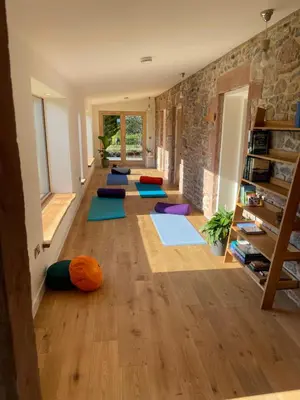a room with a row of yoga mats on the floor at The Stables - Luxury Cottage in Dumfries