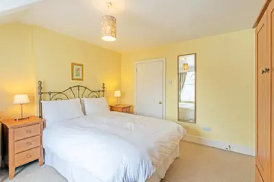a bedroom with a large white bed and a window at Keswick View in Keswick