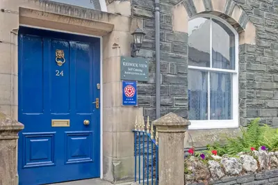 a blue door on a building with a window at Keswick View in Keswick