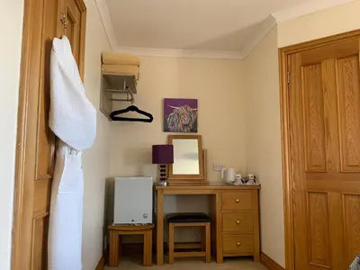 a bedroom with a dresser and a desk with a mirror at Cairnryan Bed and Breakfast in Cairnryan