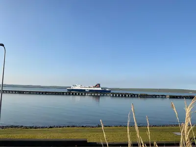 a boat is docked at a dock on the water at Cairnryan Bed and Breakfast in Cairnryan