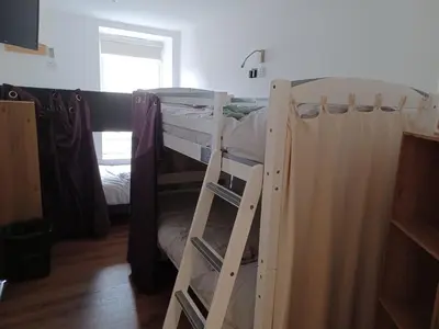 a couple of bunk beds in a room at Voyage Hostel - Rooms with Shared Kitchen in Douglas