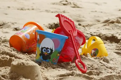 a childs toys in the sand on a beach at Beautiful Beach Front Cottage in Allonby