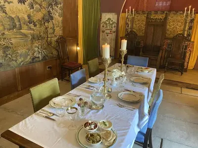 a table with plates of food on top of it at Buittle Castle Exclusive Use- Stay in your own Castle! in Castle Douglas