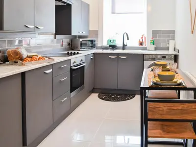 a kitchen with gray cabinets and a counter top at Cairnsmore - Uk34533 in Newton Stewart
