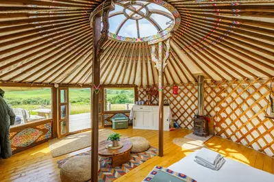 a living room with a large yurt with a window at The Kites Rest at Castle Creavie Farm in Kirkcudbright