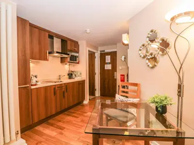 a kitchen with a glass table in a room at Cosy Corner in the Lakes in Penrith