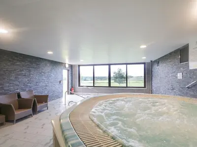 a large hot tub in a room with a couch at Cosy Corner in the Lakes in Penrith