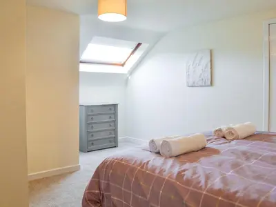 a bedroom with a bed with two pillows on it at Cairncroft Cottage in Colfin