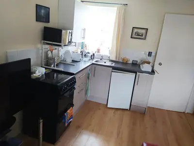 a kitchen with a sink and a stove top oven at Haven Apartments in Whitehaven