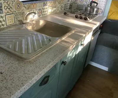 a kitchen counter with a sink and a stove at Dobbin the horse box in The Lake District in Cockermouth