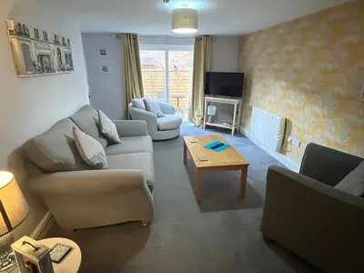 a living room with two couches and a coffee table at Petteril House - Ground Floor in Carlisle
