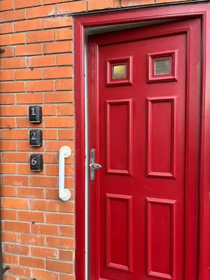 a red door on a brick building at Petteril House - Ground Floor in Carlisle