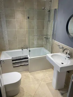 a bathroom with a sink and a tub and a toilet at Flosh Cottage Lake District in Cleator