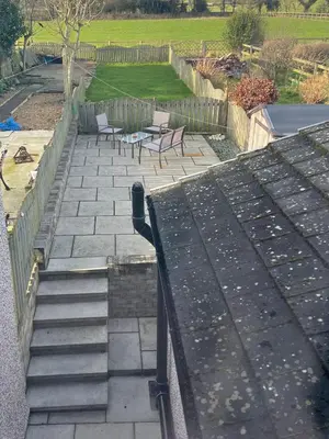 a set of stairs leading to a patio with chairs at Flosh Cottage Lake District in Cleator
