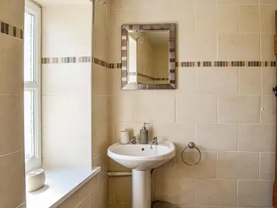 a bathroom with a sink and a mirror at Mullhill in Ardwell