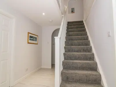 a staircase in a home with white walls at Waters Edge in Stranraer