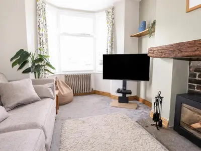 a living room with a couch and a flat screen tv at Dovestones in Keswick
