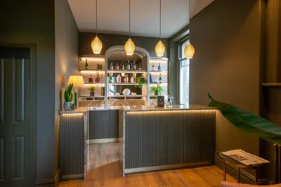 a bar in a restaurant with a counter at Fellpack House in Keswick