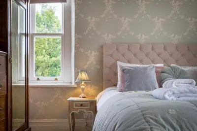 a bedroom with a bed and a window at Swinside Lodge in Keswick