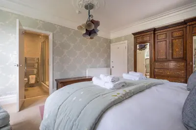 a bedroom with a bed with towels on it at Swinside Lodge in Keswick