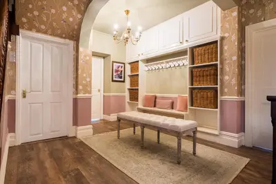 a walk in closet with a bench in a room at Swinside Lodge in Keswick