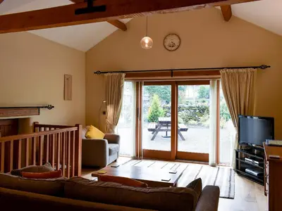 a living room with a couch and a tv at Hilltoft Barn in Dockray