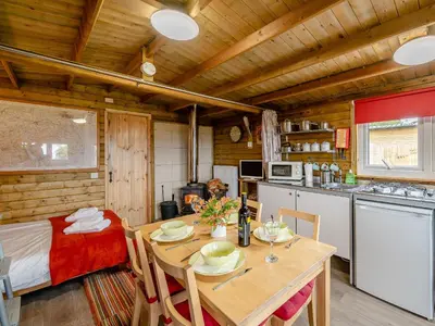 a kitchen and dining room with a table in a cabin at Starling Lodge - Uk31071 in Westward