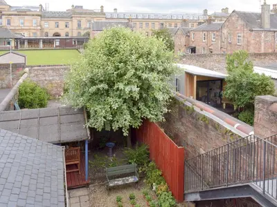 an overhead view of a courtyard with a tree and a building at Charlotte Street in Ayr