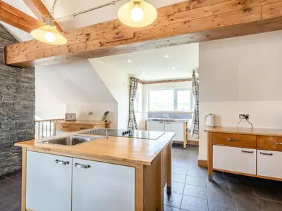 a kitchen with white cabinets and a wooden ceiling at Seaviews And Hot Tub At Admirals Anchor in Portpatrick