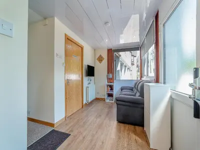 a living room with a couch and a window at 1 Ladyknowe - Uk39970 in Moffat