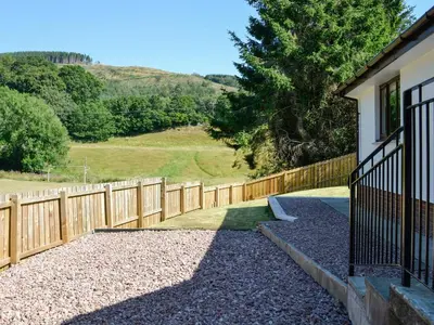 a wooden fence in front of a house at Park Lane in Auldgirth