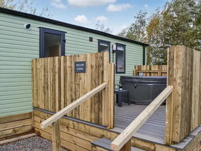 a wooden deck in front of a tiny house at Willow - Uk36374 in Westward