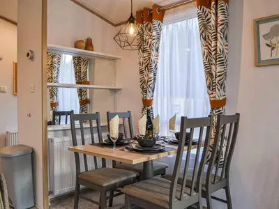 a dining room with a table and chairs and a dining room at Willow - Uk36374 in Westward