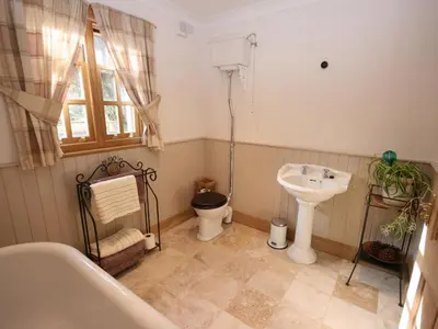 a bathroom with a sink and a toilet at Gardener's Cottage in Girvan