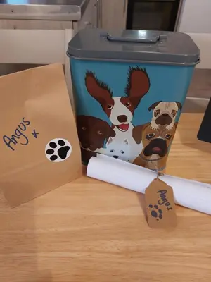 a trash can with dogs on it sitting on a table at Hill Street Cottage in Portpatrick